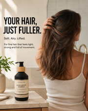 Woman with long brown hair beside Vassia Labs Scalp Support Shampoo in a bright bathroom
